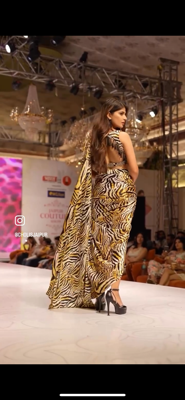 Bold and captivating saree features a striking leopard print